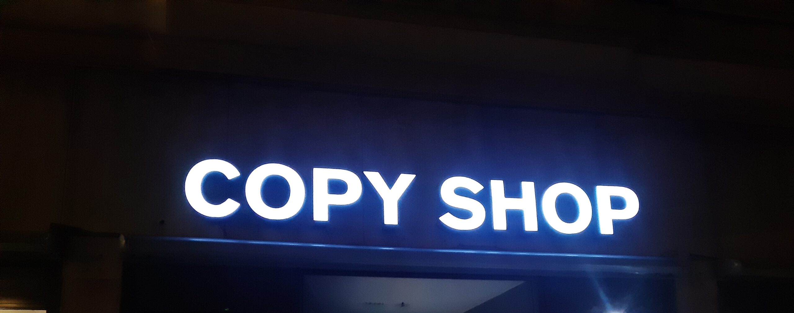 Leuchtender Schriftzug „COPY SHOP“