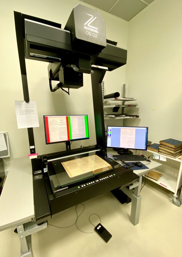 Zeutschel OS Q2 Aufsichtsscanner mit aufgeschlagenem Buch und Kontrollmonitoren
